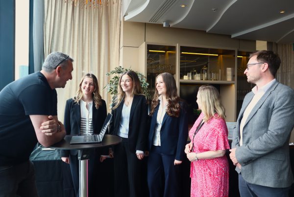 An informal conversation between students and an instructor during a Junior Trader Q&A session, encouraging open discussion around financial literacy.