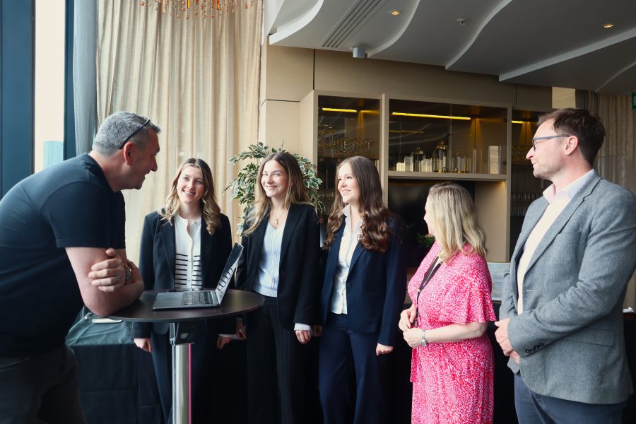 An informal conversation between students and an instructor during a Junior Trader Q&A session, encouraging open discussion around financial literacy.