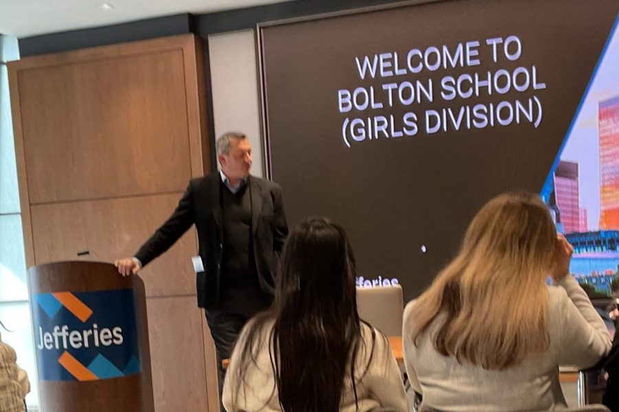 A group of participants attending a Junior Trader finance and investing workshop, captured during an informal networking session in a corporate learning space.